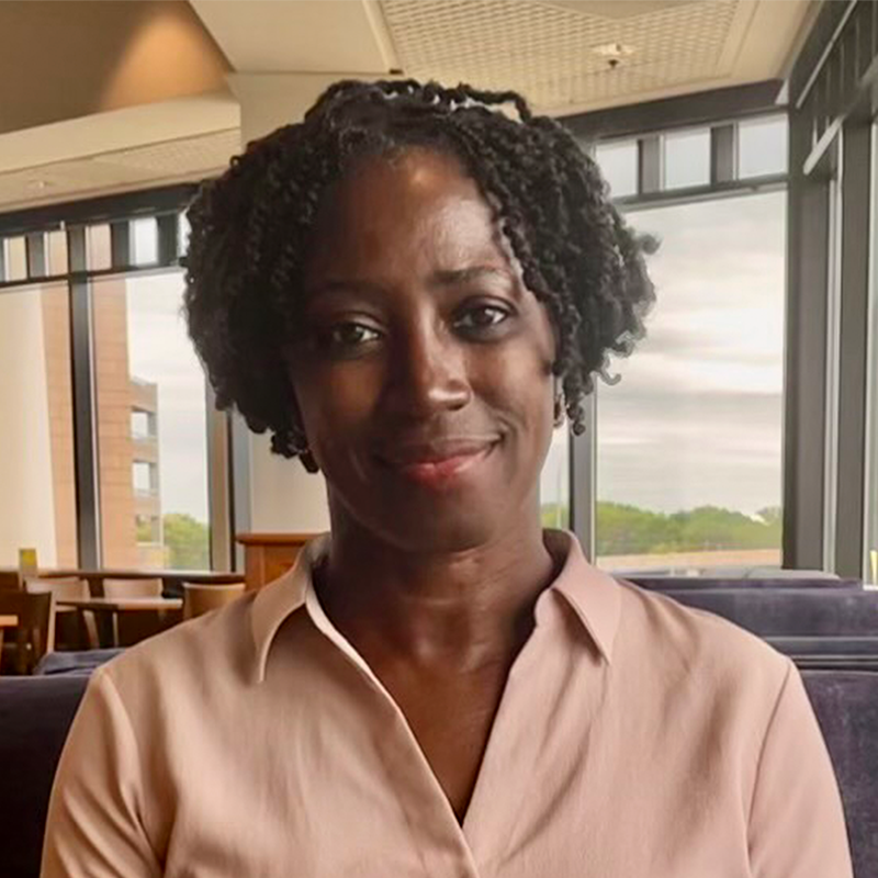 Photo of Micheline Mutombo-Harris smiling.